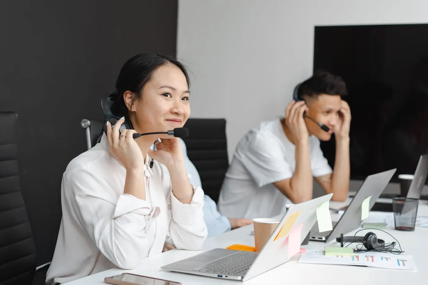 Support team with headsets in a modern office