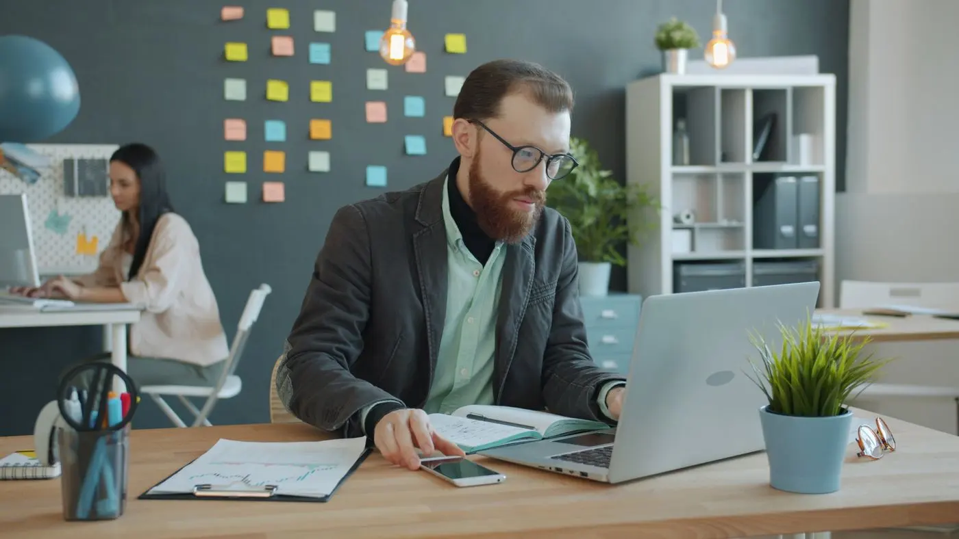 Employee focused on a laptop in the office