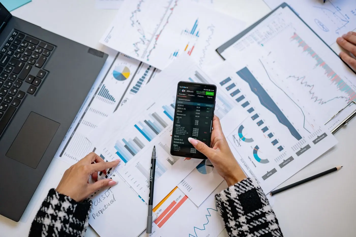 Reports and a smartphone on a desk