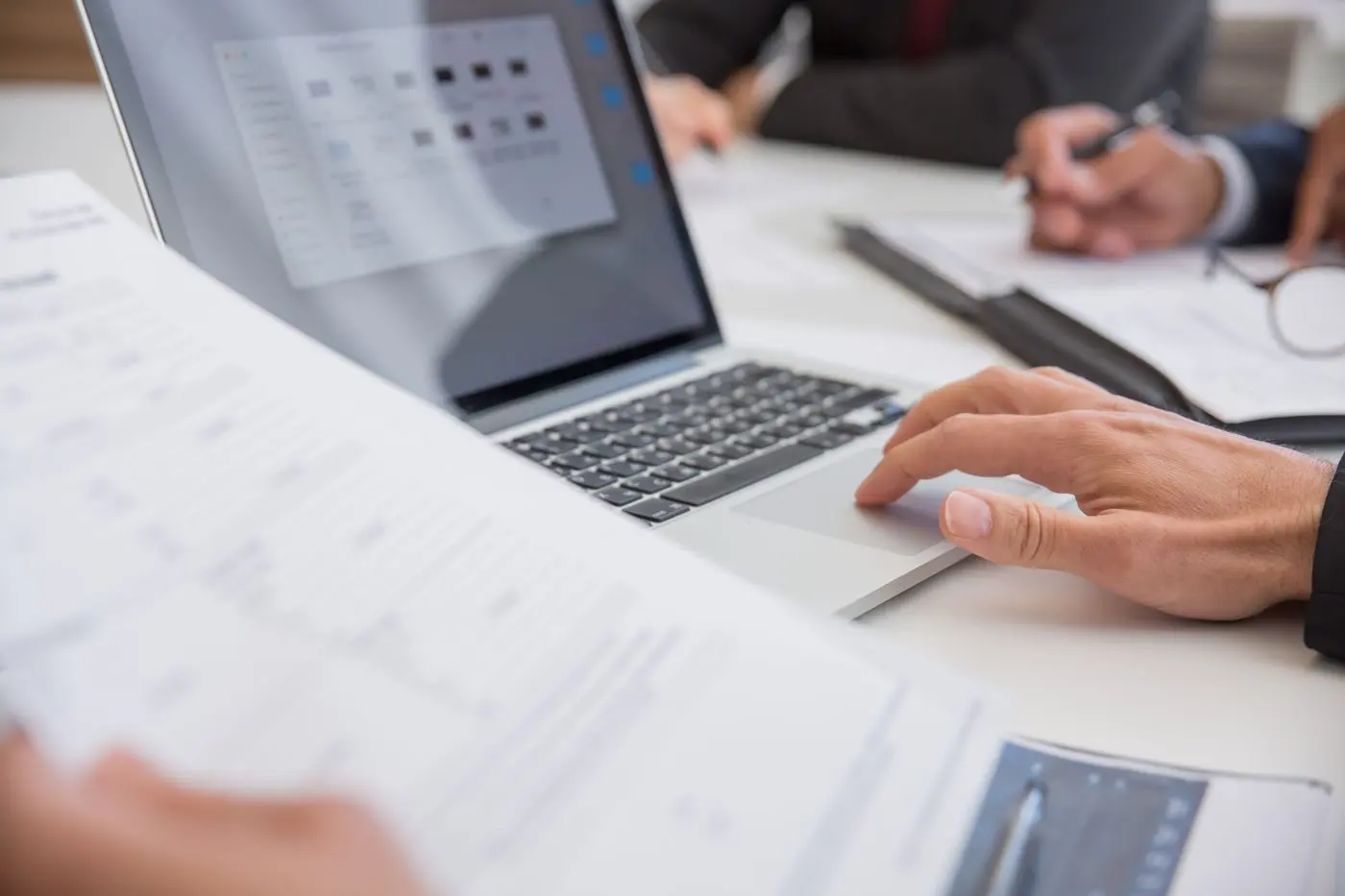 Documents and a laptop on a desk